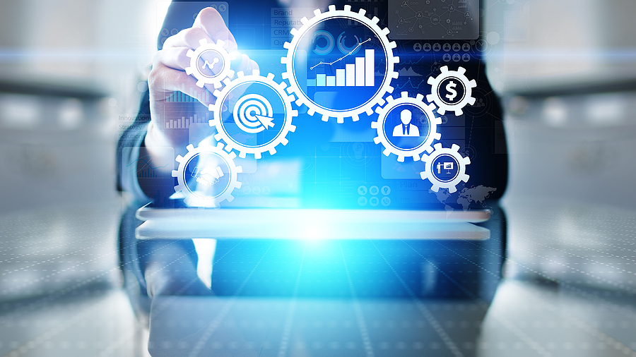 A business professional is shown selecting virtual gears in the foreground of the image, suggesting an automated workflow.
