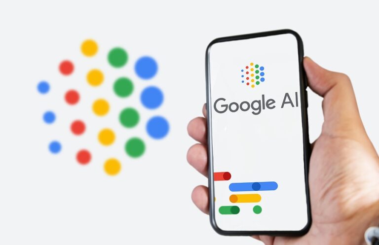 A hand holding a phone with the Google AI logo on the screen. White background with blurred logo.
