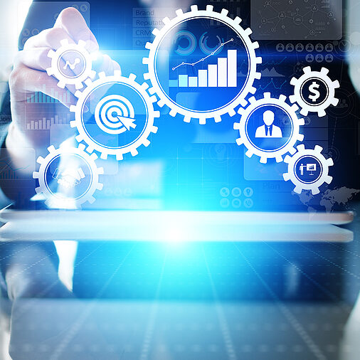 A business professional is shown selecting virtual gears in the foreground of the image, suggesting an automated workflow.