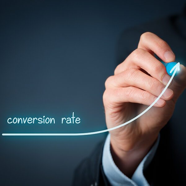 Businessperson draws growing graph of rising conversion rate.